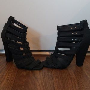 Black strappy peep heels.